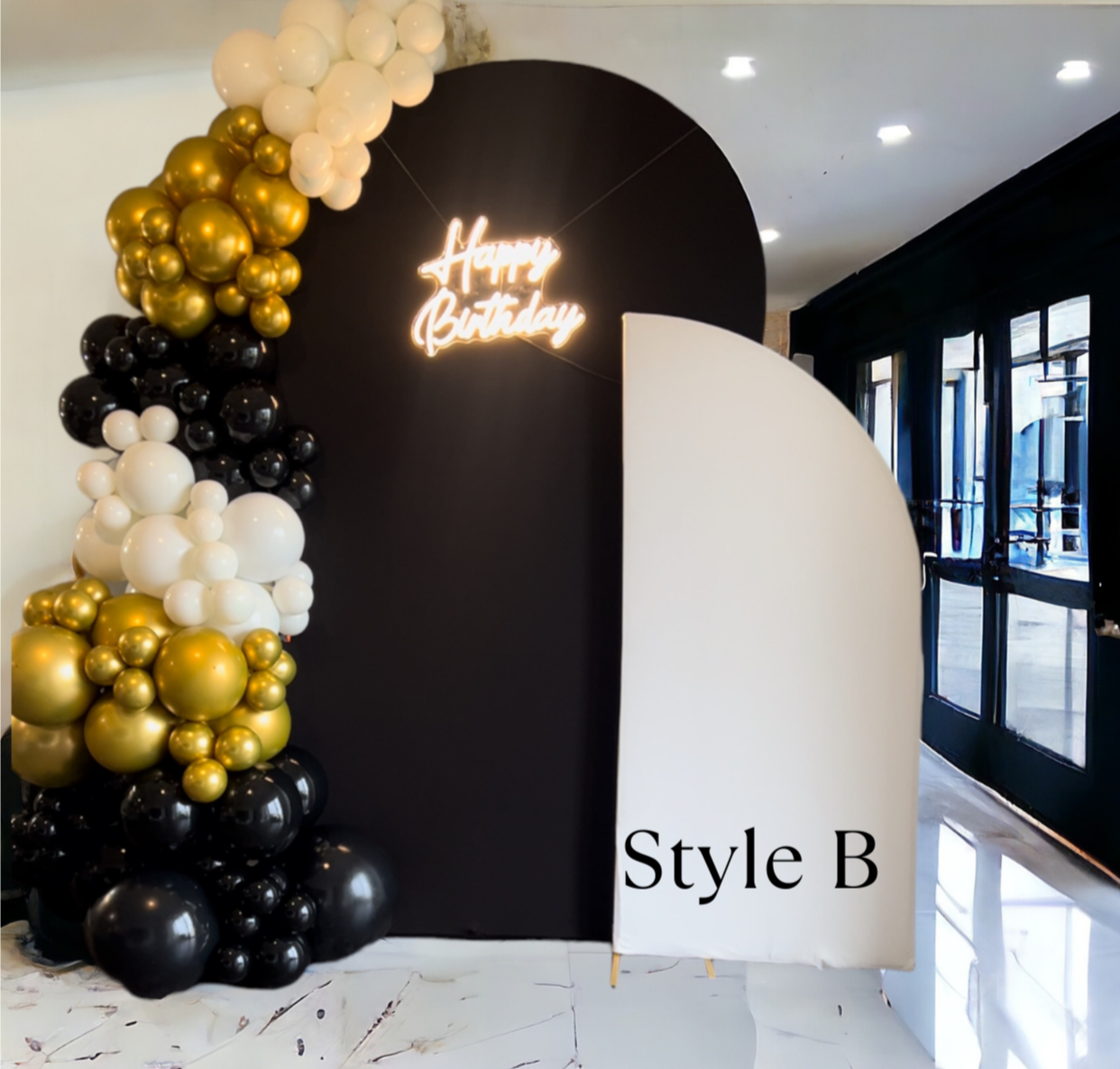 Black, Gold and White Balloon Garland on Two Chiara Arches with a neon Happy Birthday Sign